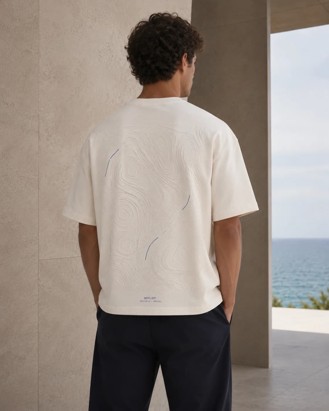 T-001 / ORIGIN worn in a concrete structure above the sea.
